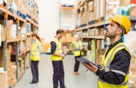 Warehouse Manager Writing on Clipboard